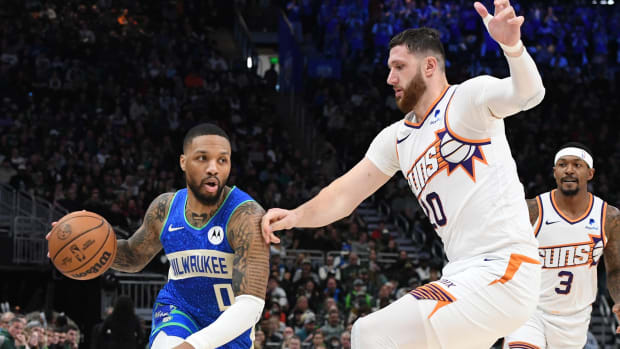 Milwaukee Bucks guard Damian Lillard (0) drives against Phoenix Suns center Jusuf Nurkic (20)